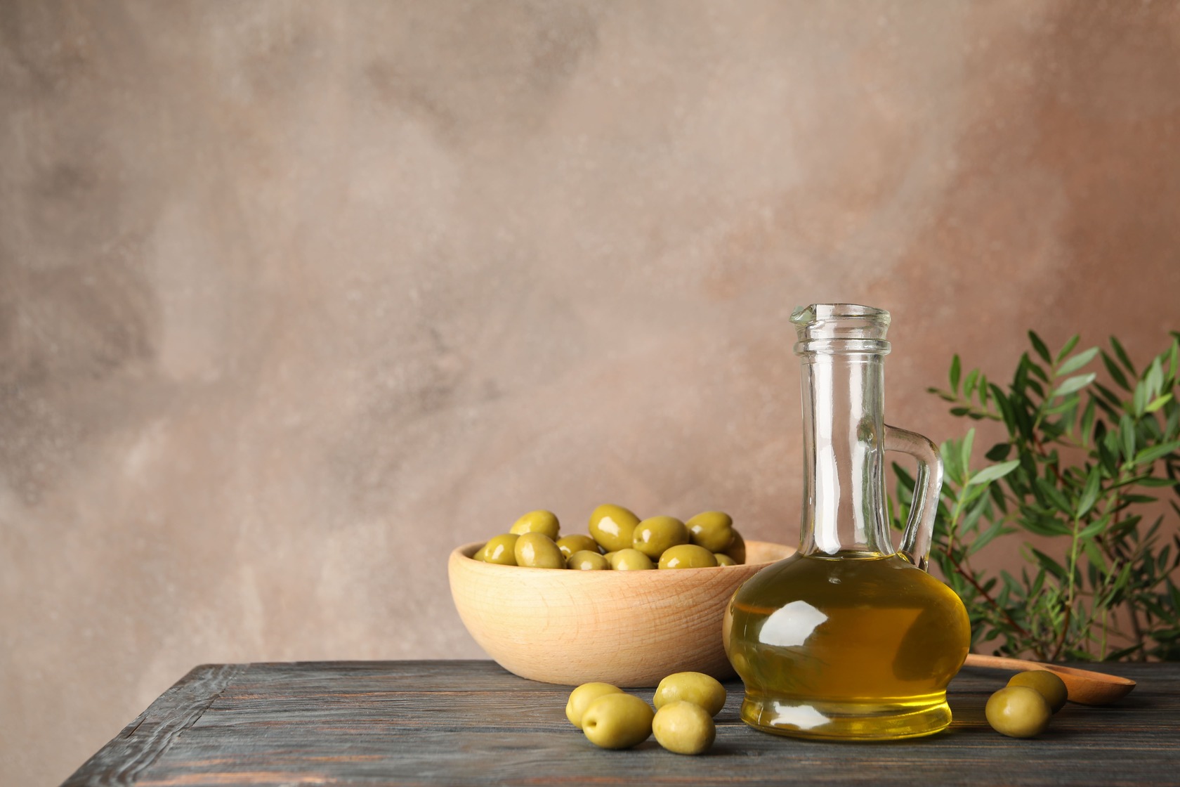 composition-with-olive-oil-and-olives-on-wooden-ta-2021-09-02-20-17-06-utc-1.jpg